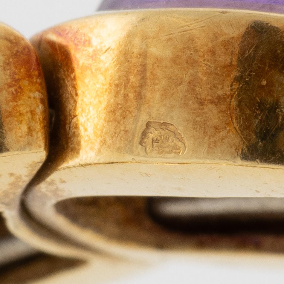 Bracelet in 18K gold set with cabochon-cut citrine, amethyst, pink tourmaline, peridot, and aquamarine.