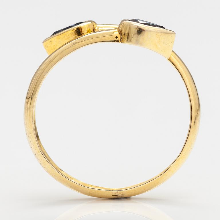 An 14-18K gold ring with two sapphires.
