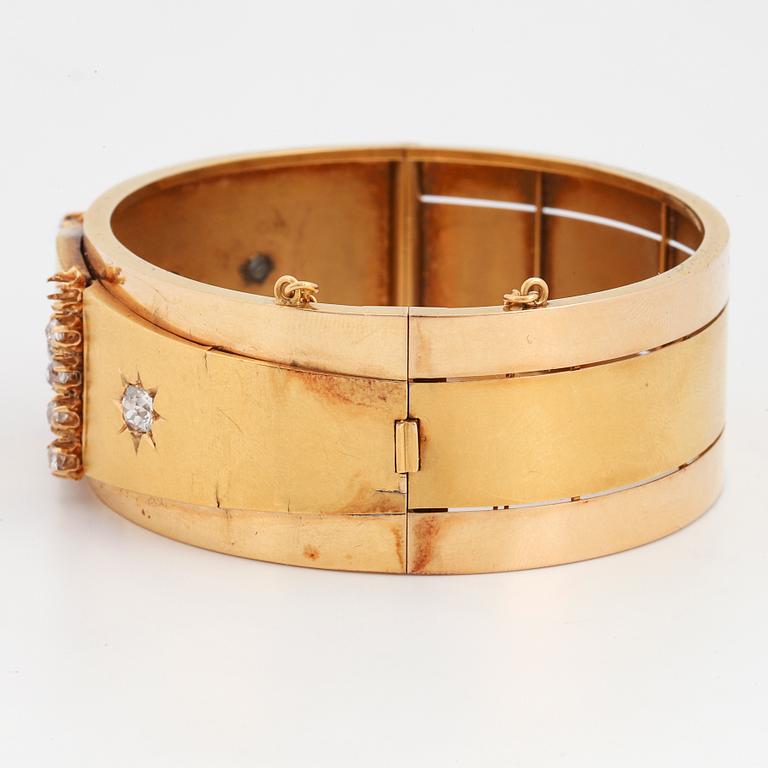 An 18K gold bracelet set with old-cut diamonds.
