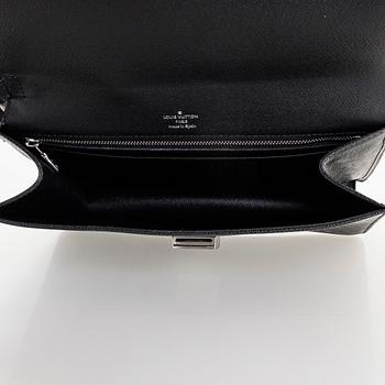 Louis Vuitton, a 'Selenga' clutch bag.