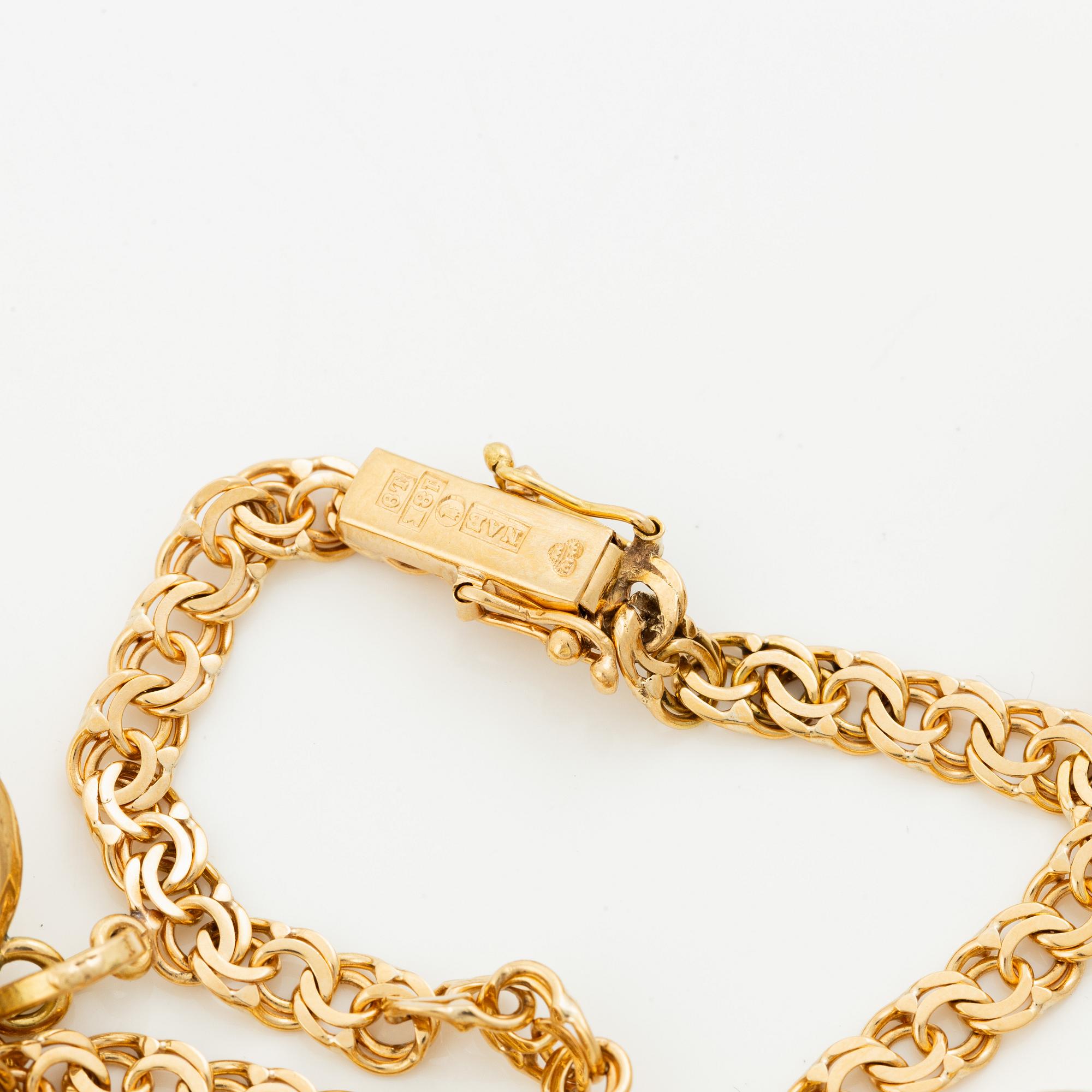 Bracelet, 18K gold bismarck link. With charms.