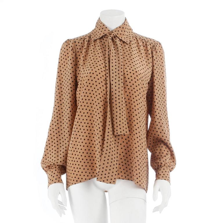 YVES SAINT LAURENT, a beige and black polka dotted blouse.