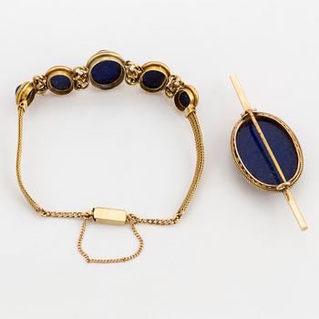 A brooch and bracelet set with cabochon cut lapis lazuli.