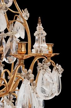 A late Baroque-style circa 1900 rock crystal twelve-light chandelier.