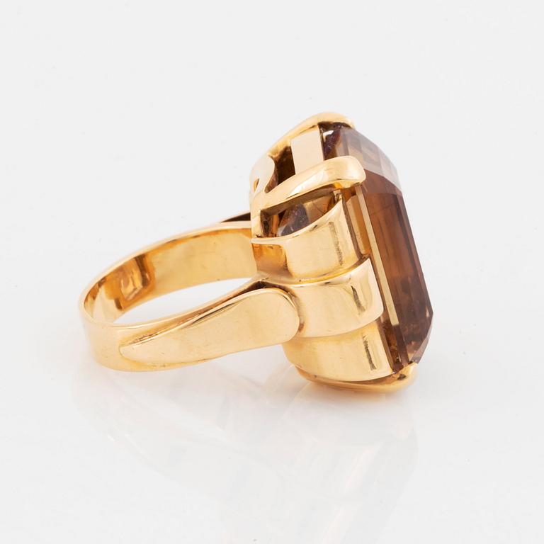 An 18K gold ring set with a step-cut citrine.