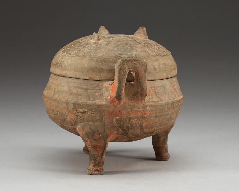 A potted ding tripod censer with cover, Han dynasty (206 BC - 220 AD).