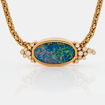 1067. An 18K gold pendant set with an opal and round brilliant-cut diamonds.