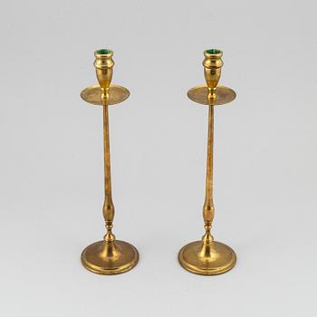 A pair of model 2539 brass candlesticks, for Firma Svenskt Tenn, designed ca 1949-50.