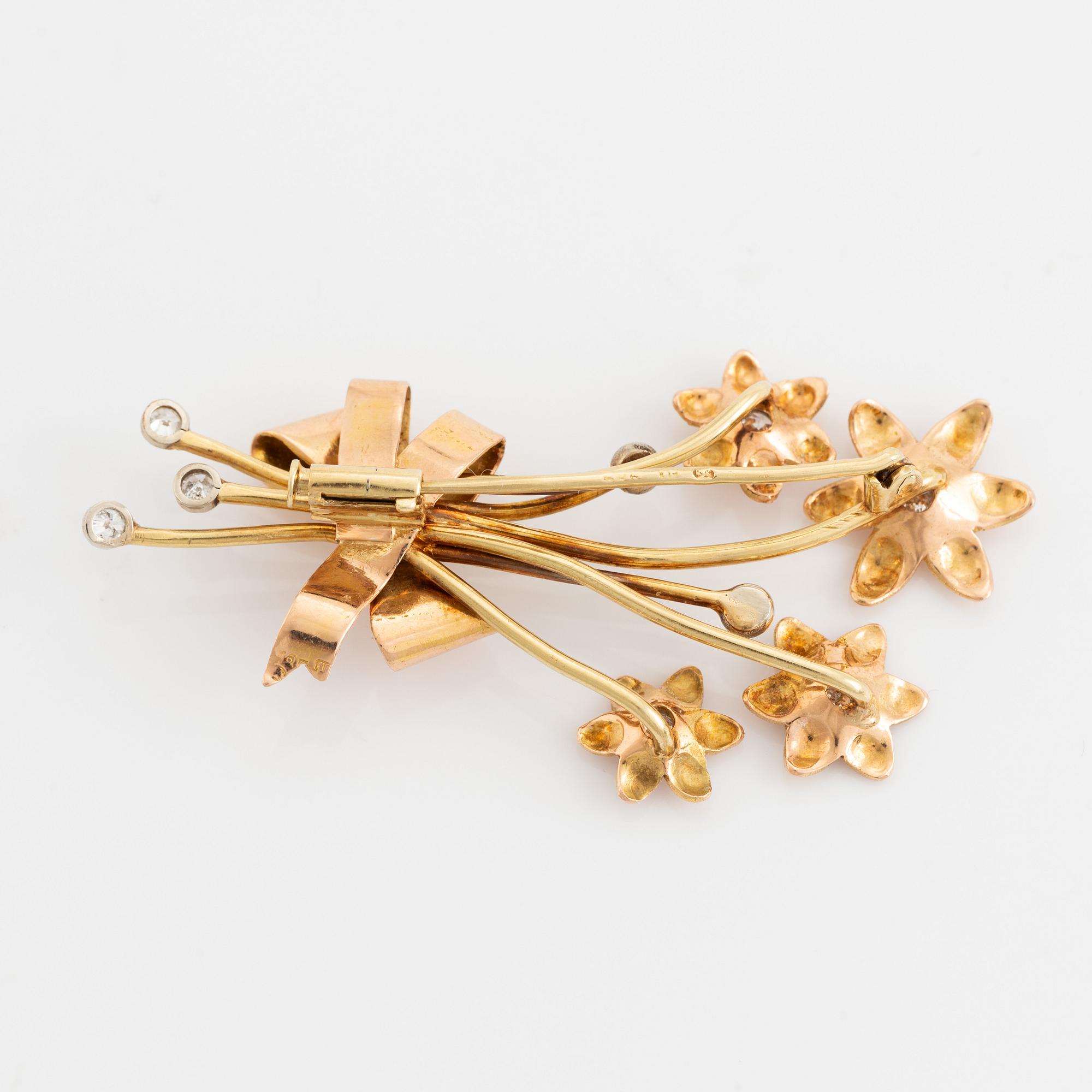 Gold and brilliant cut diamond flower brooch.
