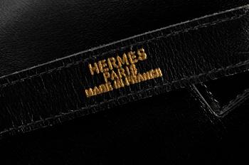A 1970s black leather handbag by Hermès, model "Trim bag".