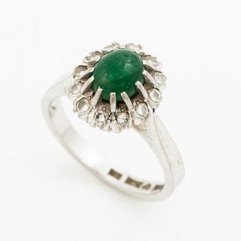 Ring, 18K white gold with cabochon-cut emerald and brilliant-cut diamonds.