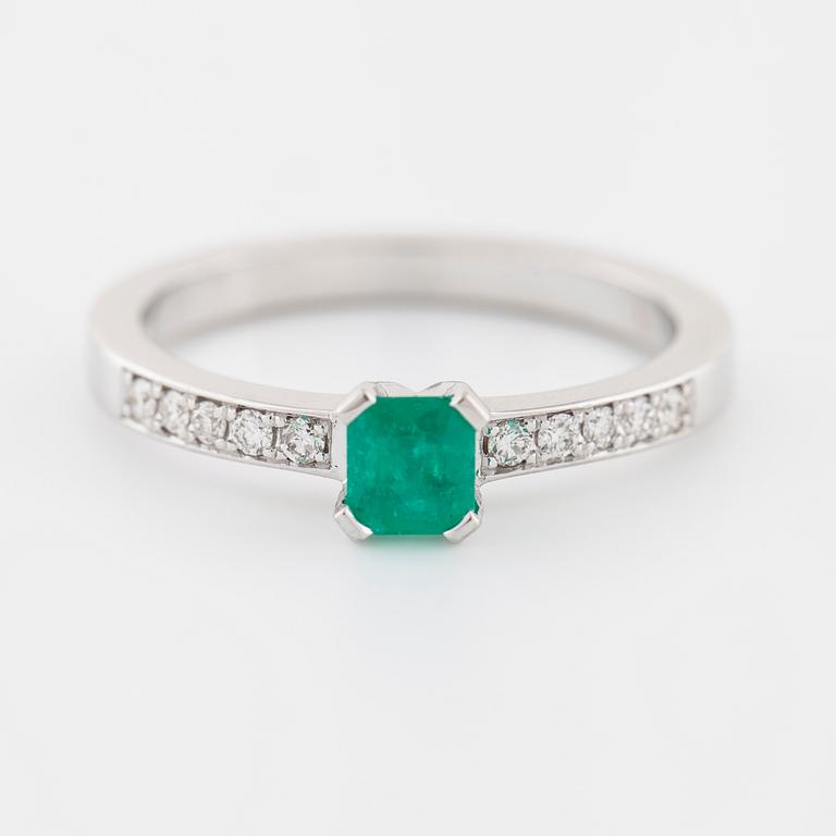 An emerald and brilliant cut diamond ring.