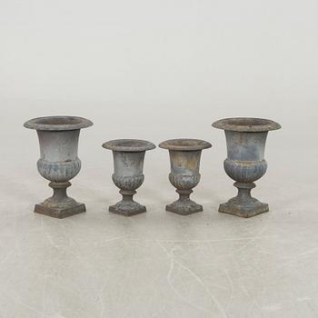 Two pairs of cast iron garden urns.