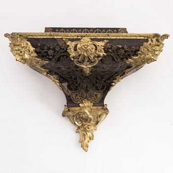 A 19th century rococo style clock, and a 18th century rococo console.