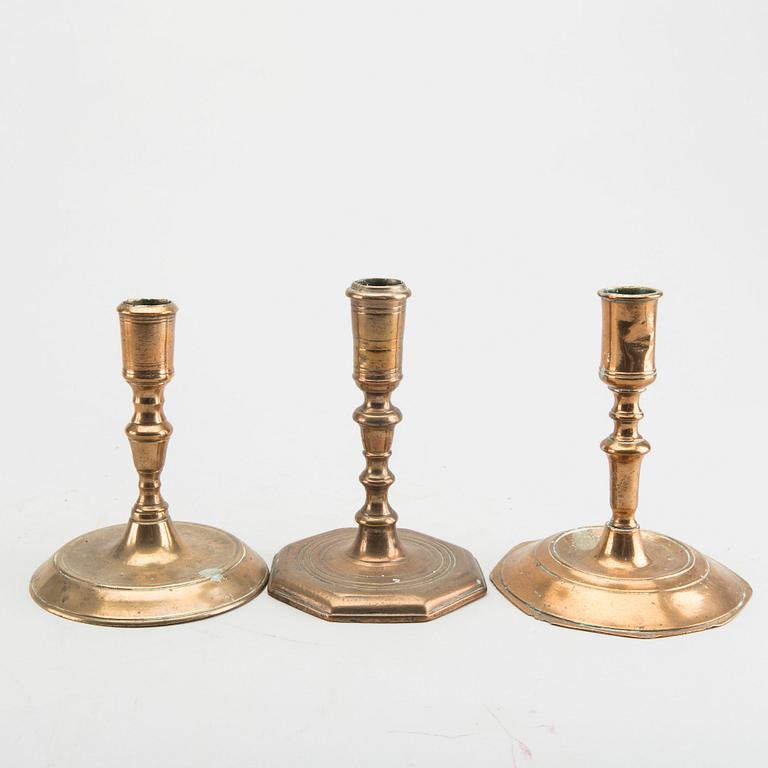 A set of five different brass late Baroque candlesticks.