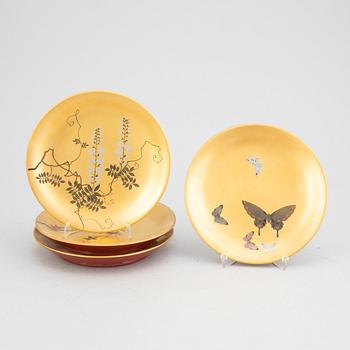 A set of six lacquered and painted Japanese plates, 20th Century.