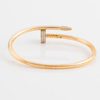 A Cartier "Juste un Clou" bracelet in 18K gold set with round brilliant-cut diamonds.