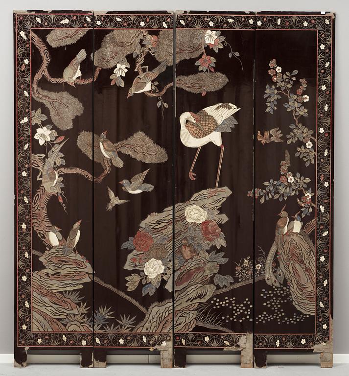A coromandel black-lacquer four panel screen, Qing Dynasty (1644-1912).