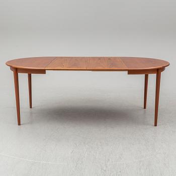 A 1960s teak veneered dining table.