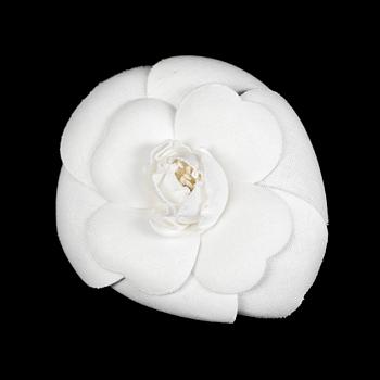 1210. A white camelia brooch by Chanel.