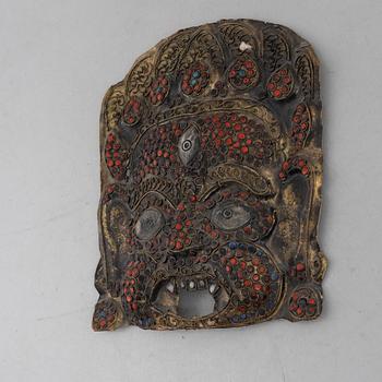 A stone inlay mask, Nepal, early 20th century.
