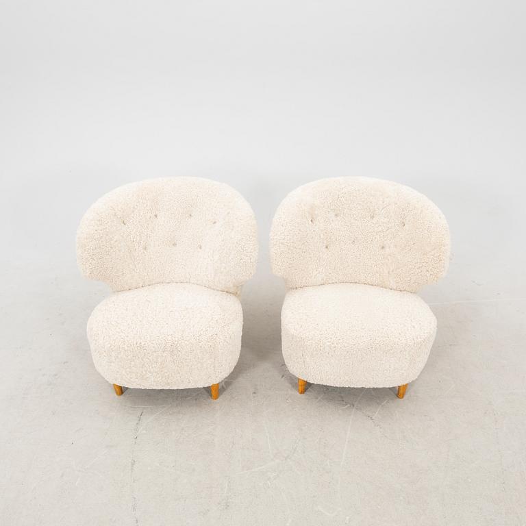 A pair of Scandinavian Modern 1940s cheepskin armchairs.