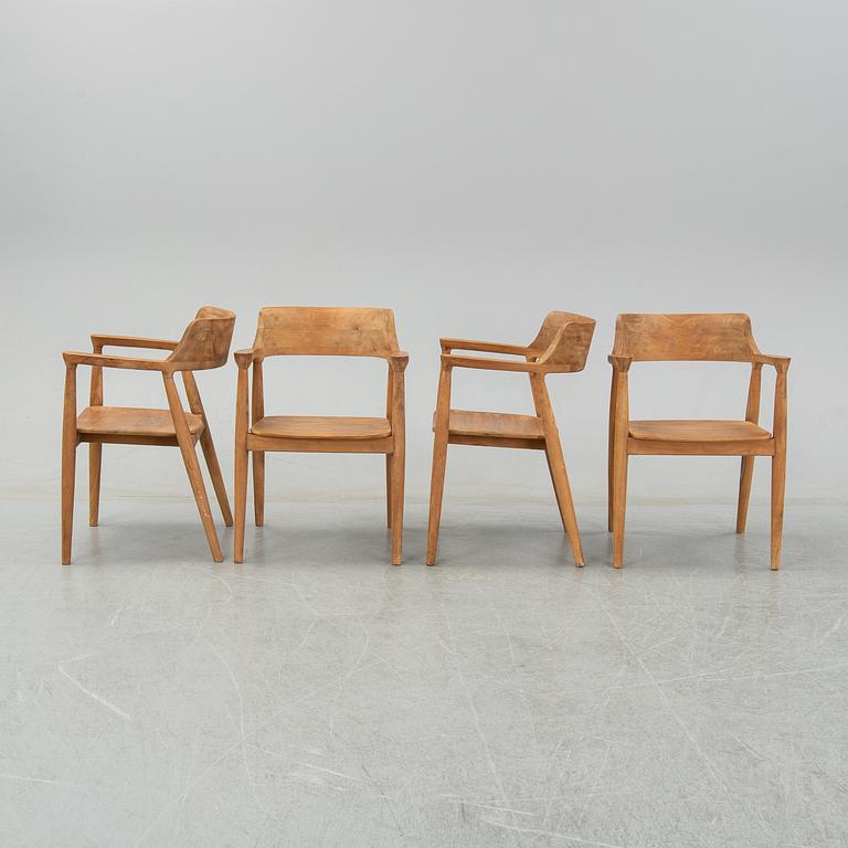 Four contemporary teak armchairs.