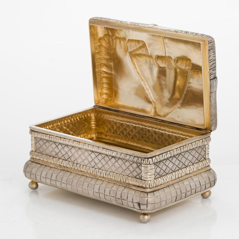 A trompe l'oeil parcel-gilt silver casket, maker's mark of Petr Loskutov, Moscow, Russia 1893.