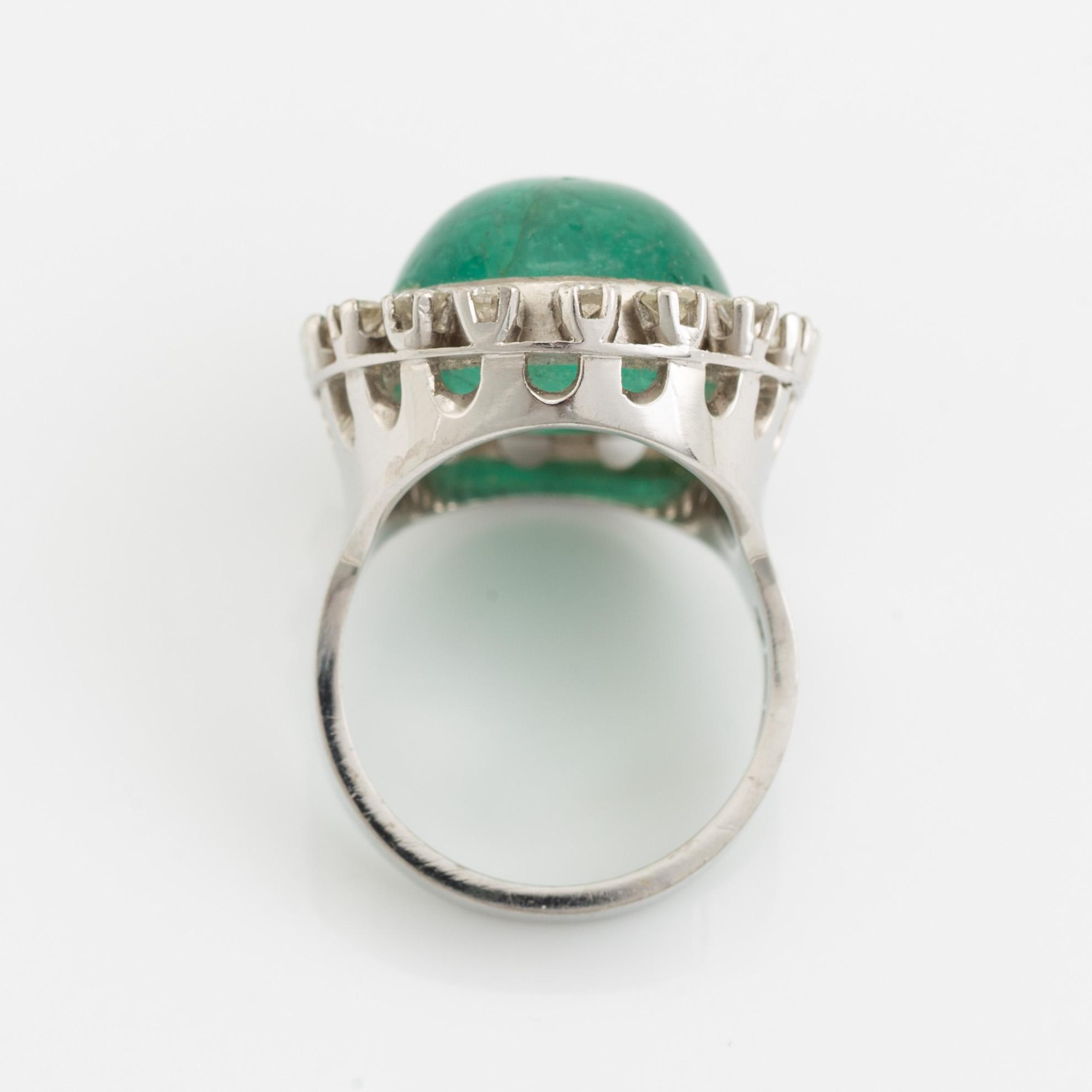Cabochon cut emerald and brilliant cut diamond ring.
