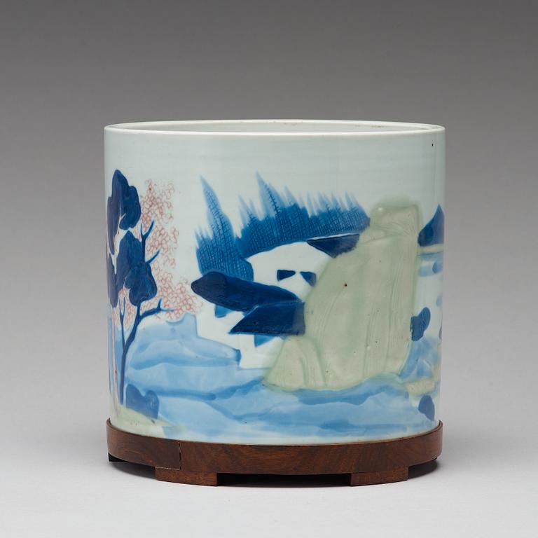 An underglaze blue, copper-red and celadon-glazed brushpot, Qing dynasty, early 18th Century, with Chenghuas mark.