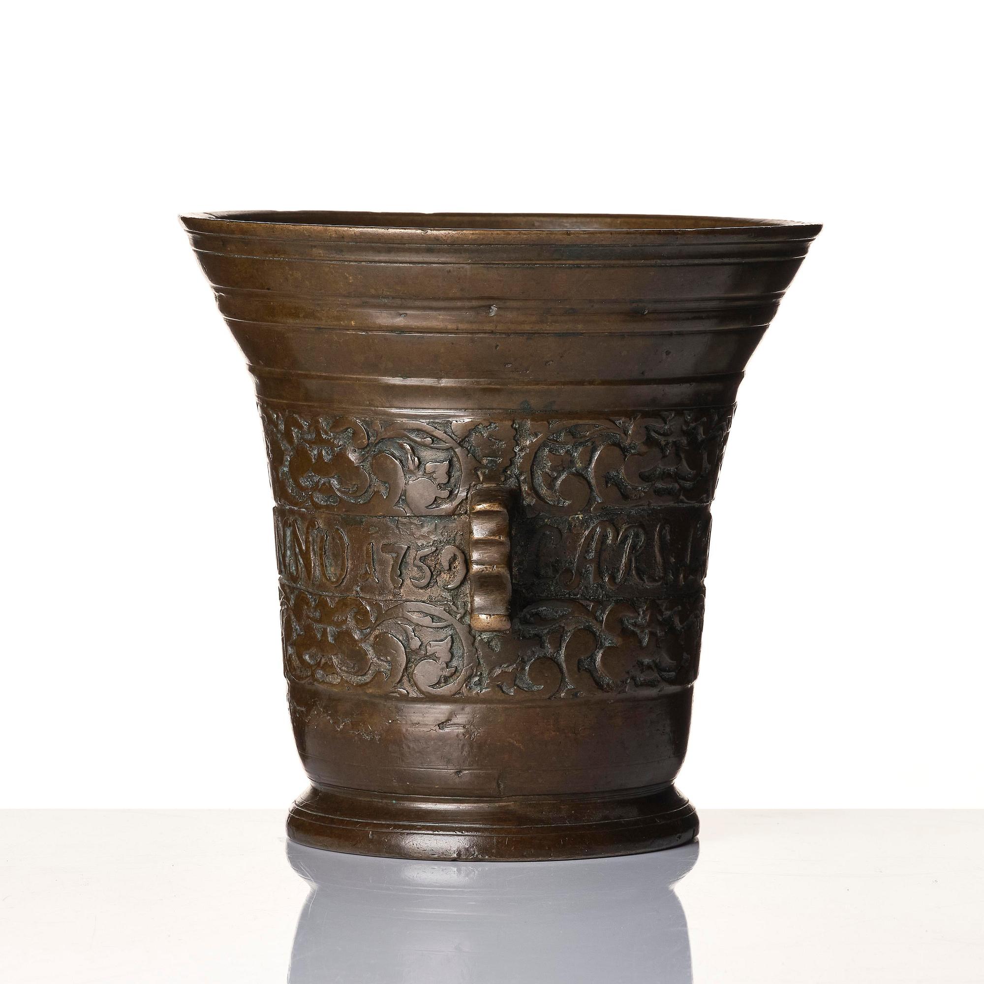 A Swedish late baroque bronze mortar and pestle, dated 1759.