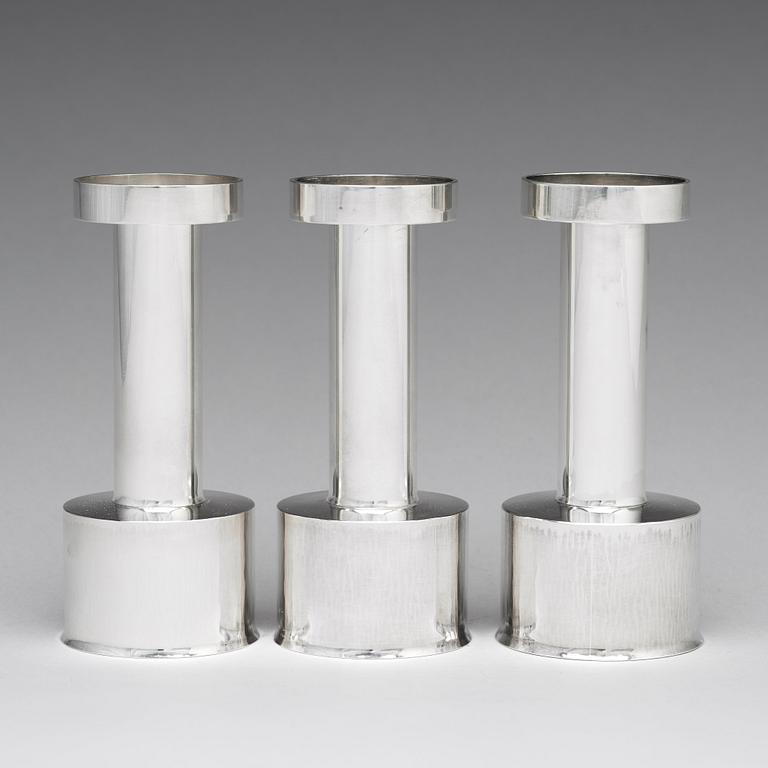 Sigurd Persson, a set of three sterling silver candlesticks, Stockholm 1965 and 1970, executed by Johann Wist.