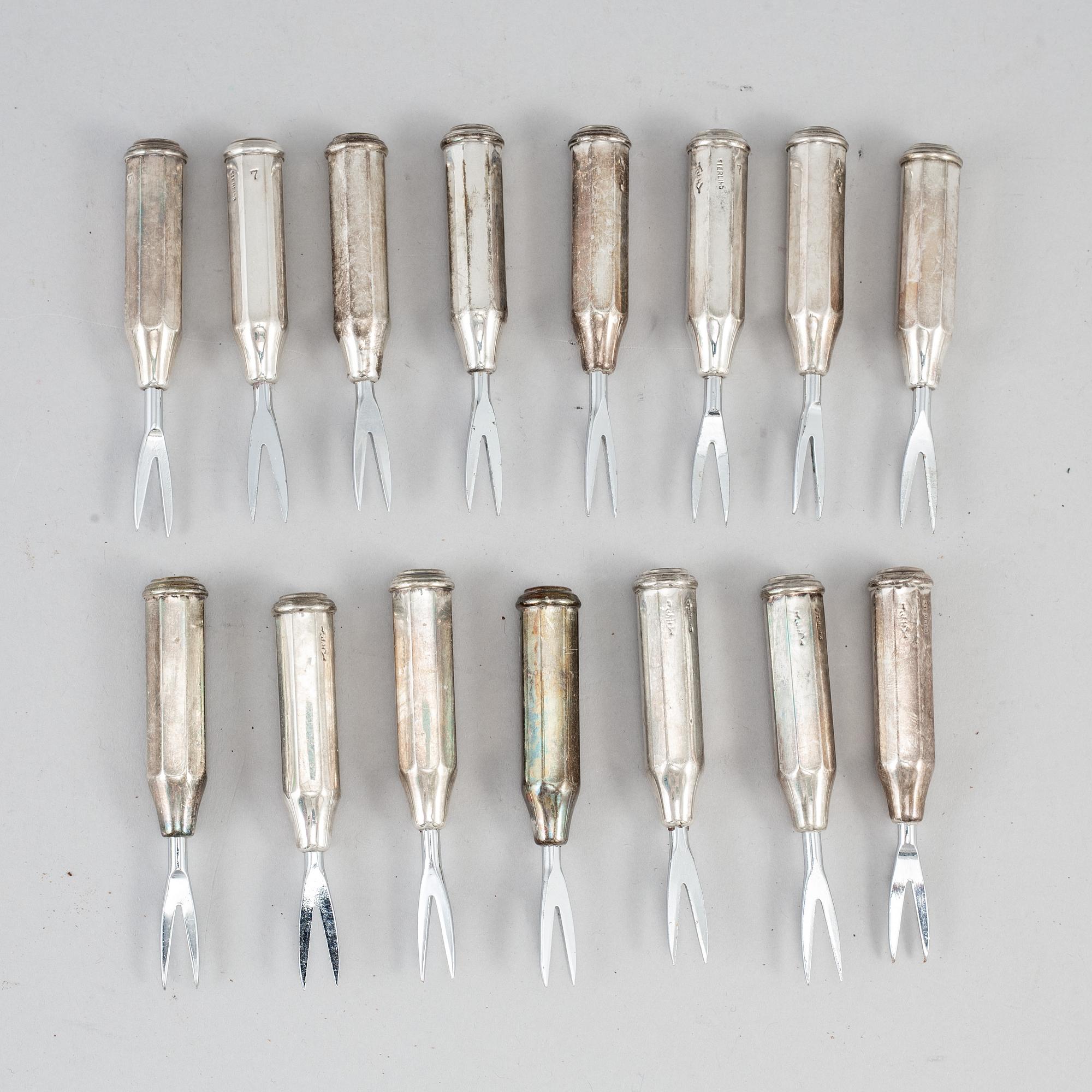 A set of seven con cob forks, sterling.
