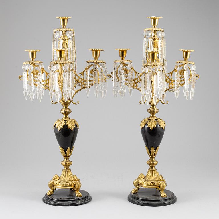 A pair of Oscarian candelabra in stone and brass.