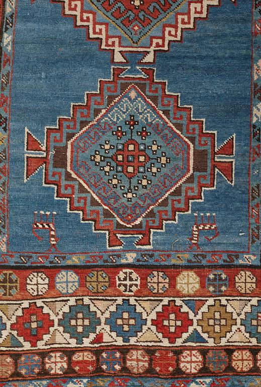 A RUNNER, a semi-antique Caucasian, ca 303,5 x 129,5-140,5 cm (as well as one end with 2,5 cm flat weave).