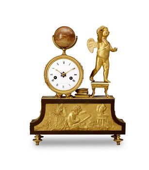 551. A French Empire early 19th Century mantel clock.