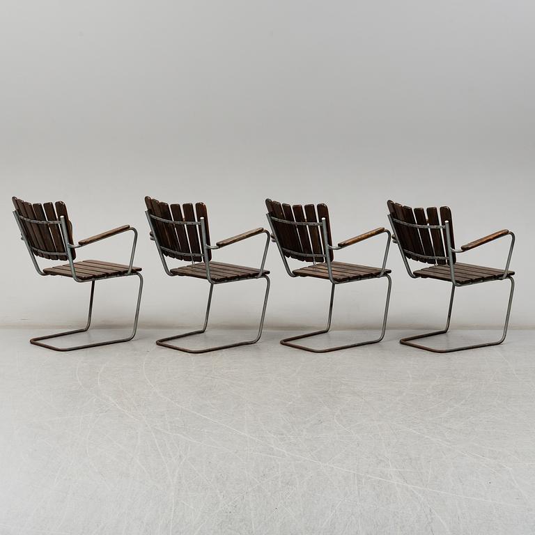 Four tubular steel and pine garden chairs, mid 20th Century.