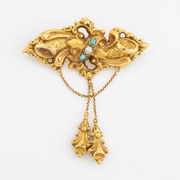 An 18K gold brooch with two cabochon cut turquoises and a pearl, end of the 19th century.