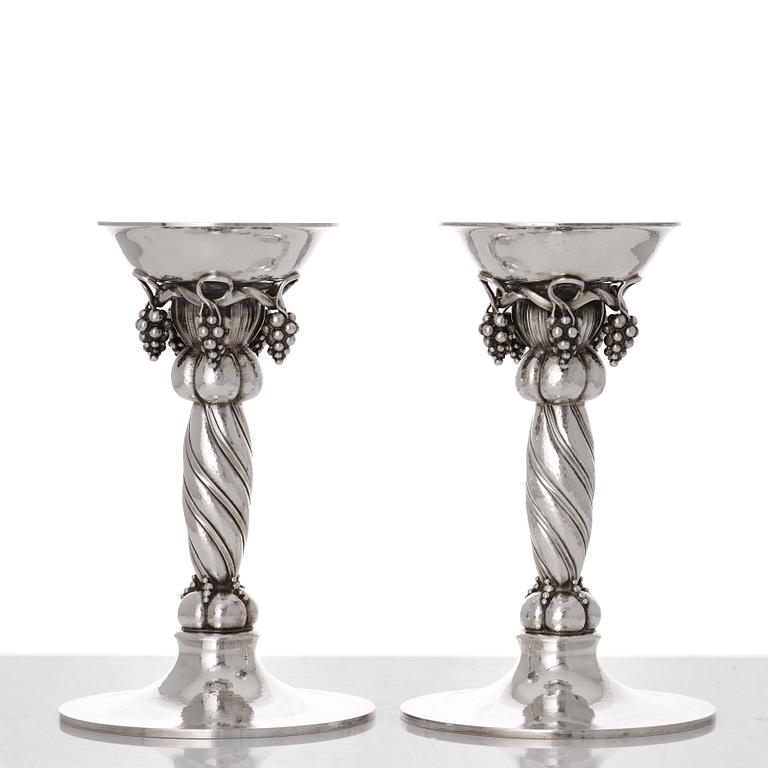 Georg Jensen, a pair of sterling silver grape decorated candlesticks, Copenhagen 1996, design nr 263B.