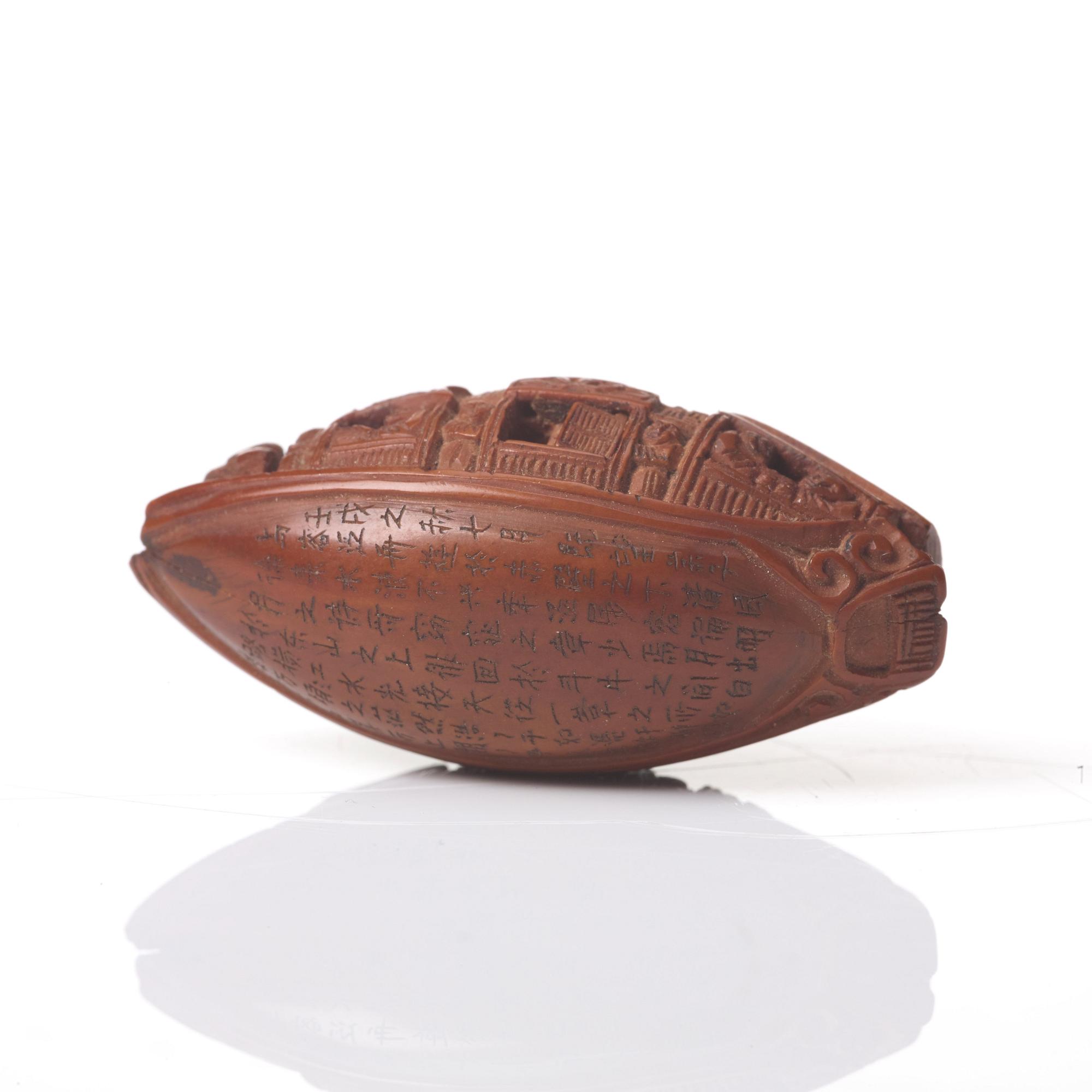 A Chinese nut boat sculpture, with poem.