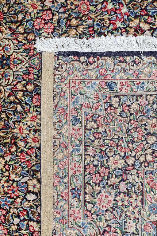 A Kirman Laver 'Millefleur' carpet, approx. 342 x 245 cm.