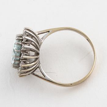 A aquamarine and brilliant cut diamond ring.