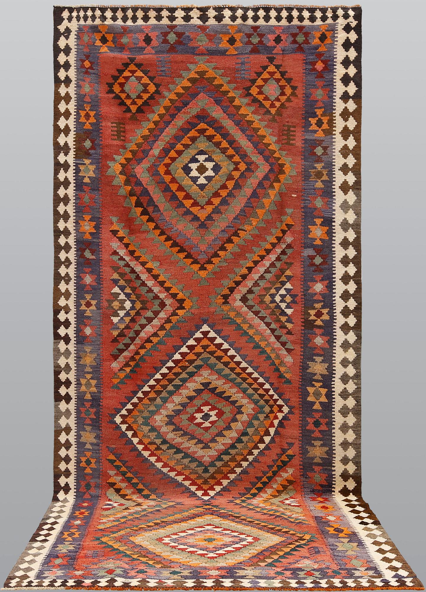 A persian nomadic kilim, approximately 420 x 190 cm.
