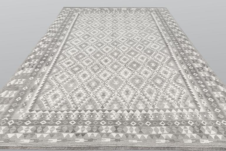 A carpet, kilim, ca 390 x 298 cm.