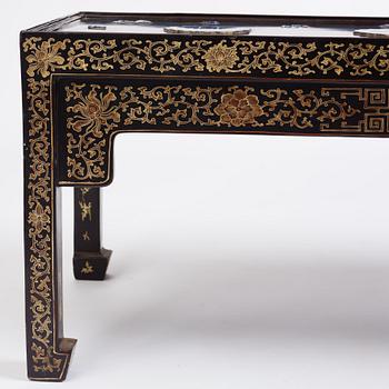 A Chinese black lacquered table with porcelain placques, presumably first half of the 20th century.