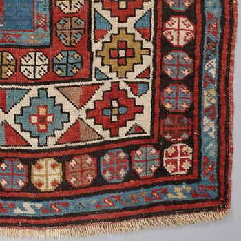 A RUNNER, a semi-antique Caucasian, ca 303,5 x 129,5-140,5 cm (as well as one end with 2,5 cm flat weave).
