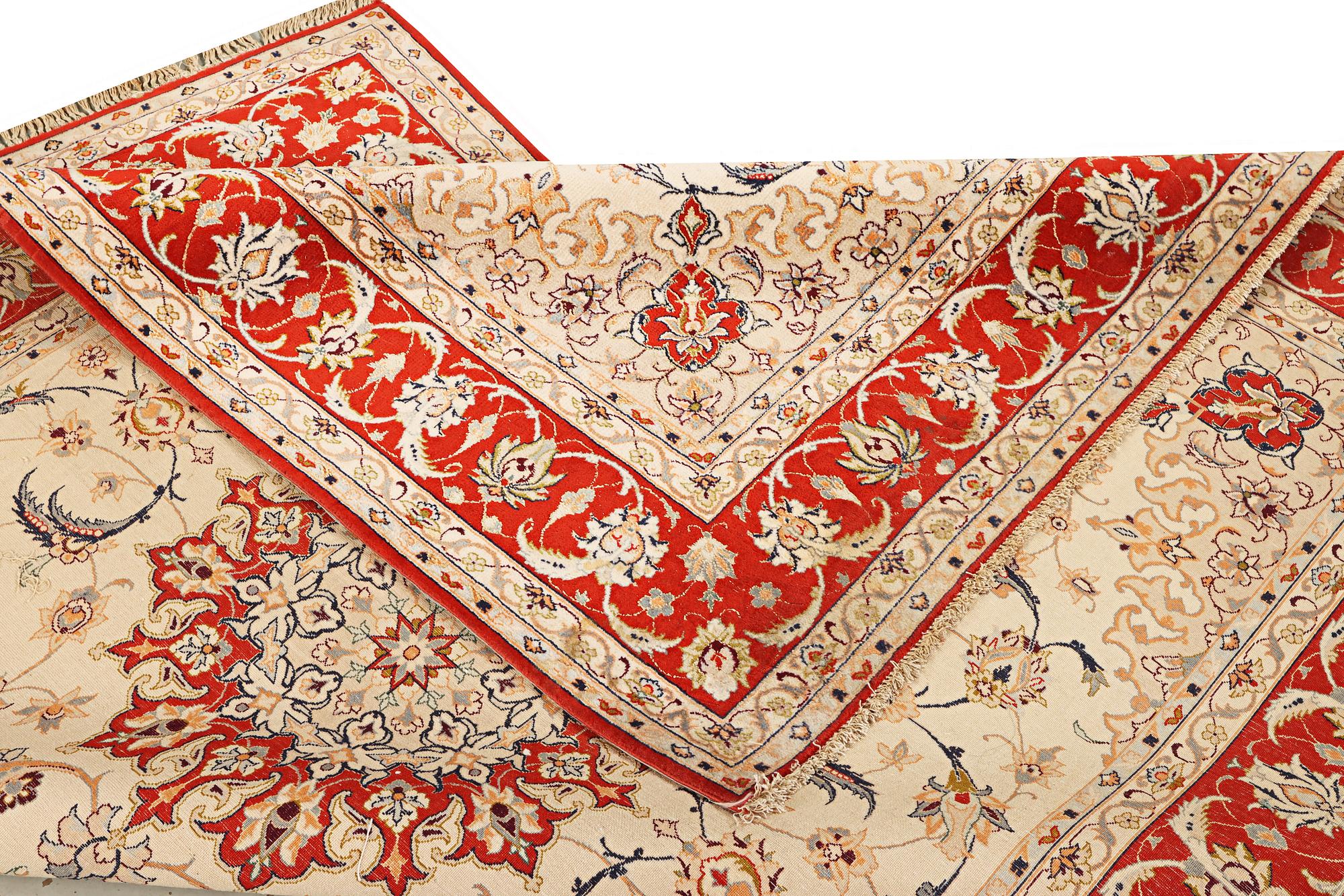 A semi-antique part silk Isfahan rug, a. 238 x 156 cm.