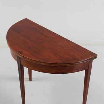 A first half od the 19th century game table veneered with mahogny.