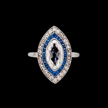 821. A navette cut diamond, app. 1.20 cts, blue sapphire and brilliant cut diamond ring.