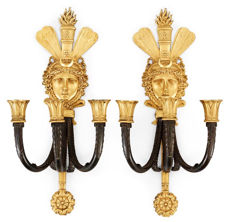 A pair of French Empire three-light wall-lights.